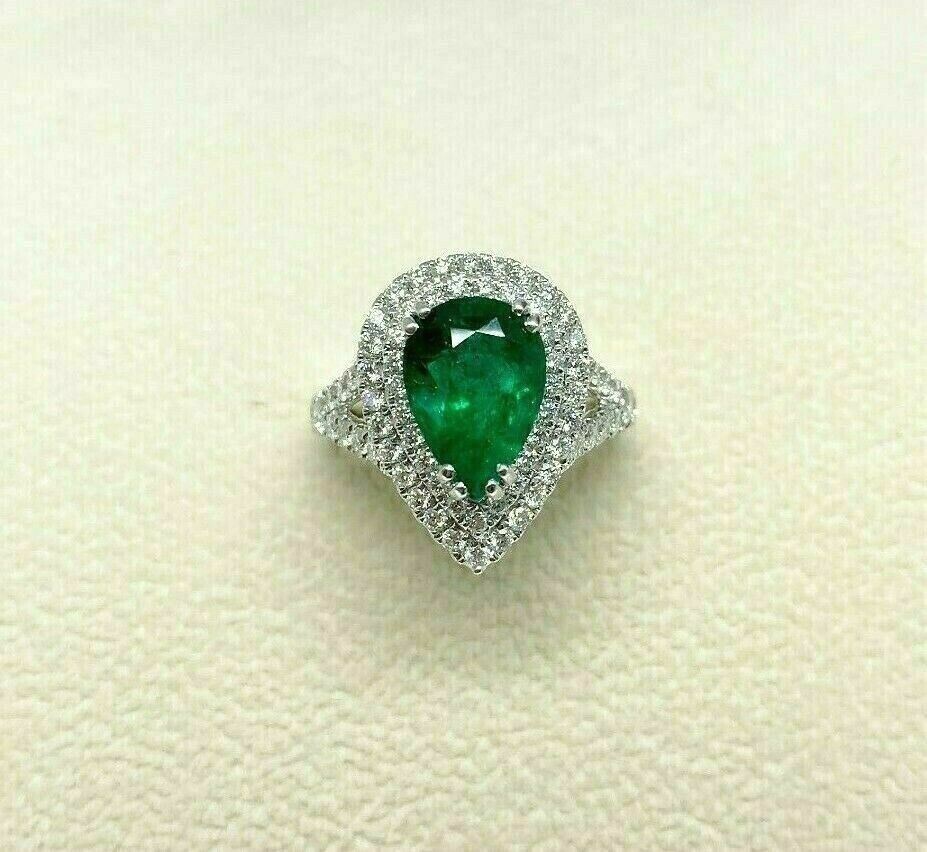 4.02 Carats t.w. Diamond and Emerald Halo Ring 18K Gold Emerald is 2.85 Carats