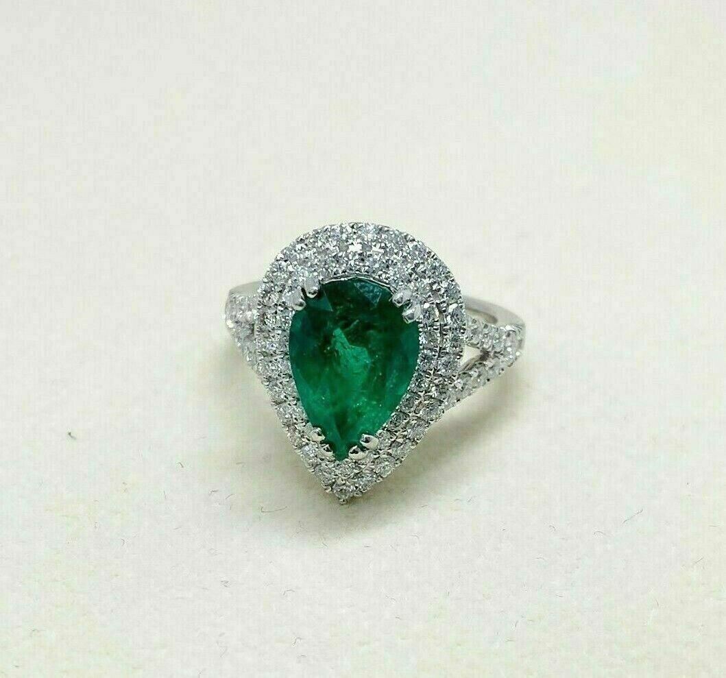 4.02 Carats t.w. Diamond and Emerald Halo Ring 18K Gold Emerald is 2.85 Carats