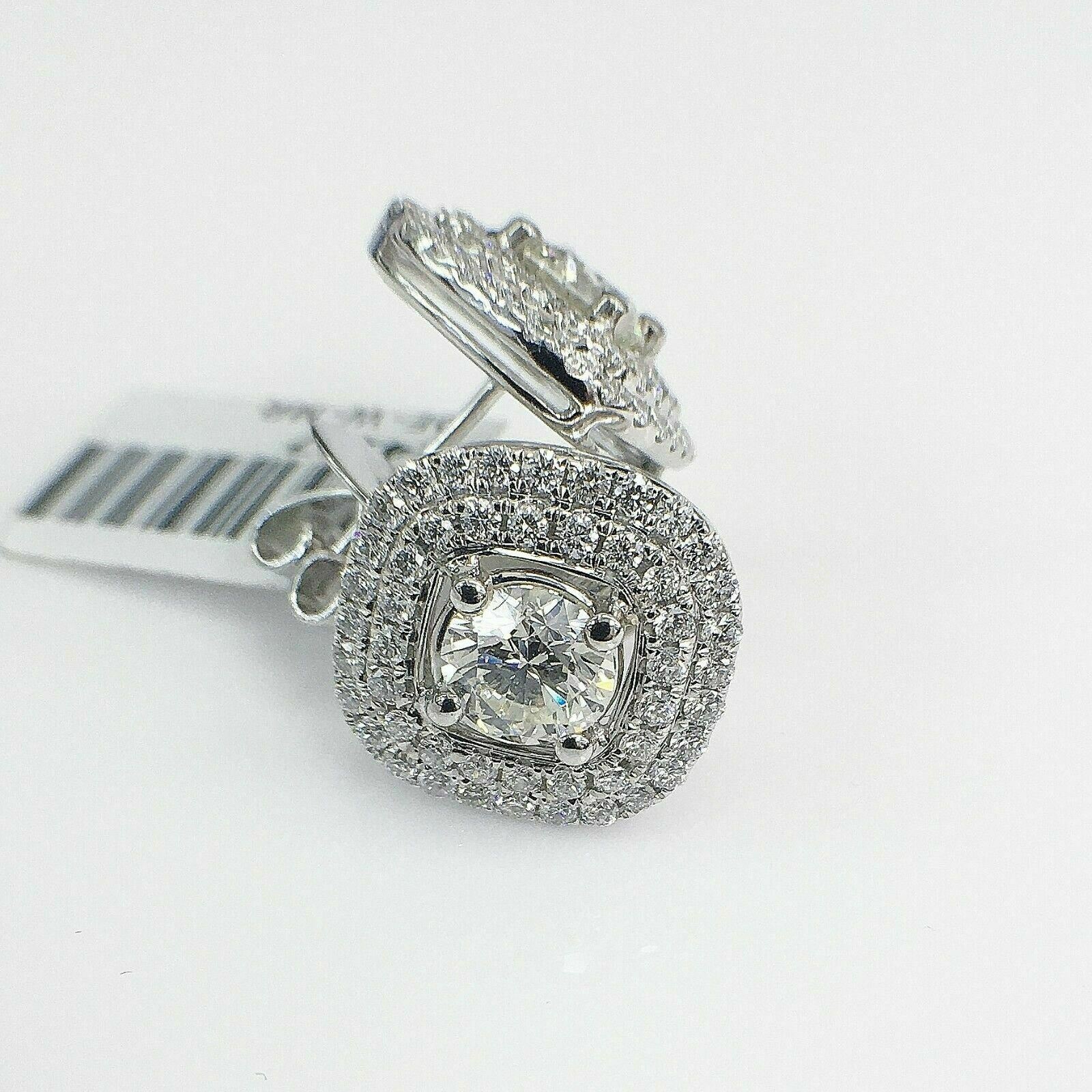 2.83 Carats t.w. Diamond Halo Earrings Center Diamonds are 1.41 Ct t.w. 18K Gold