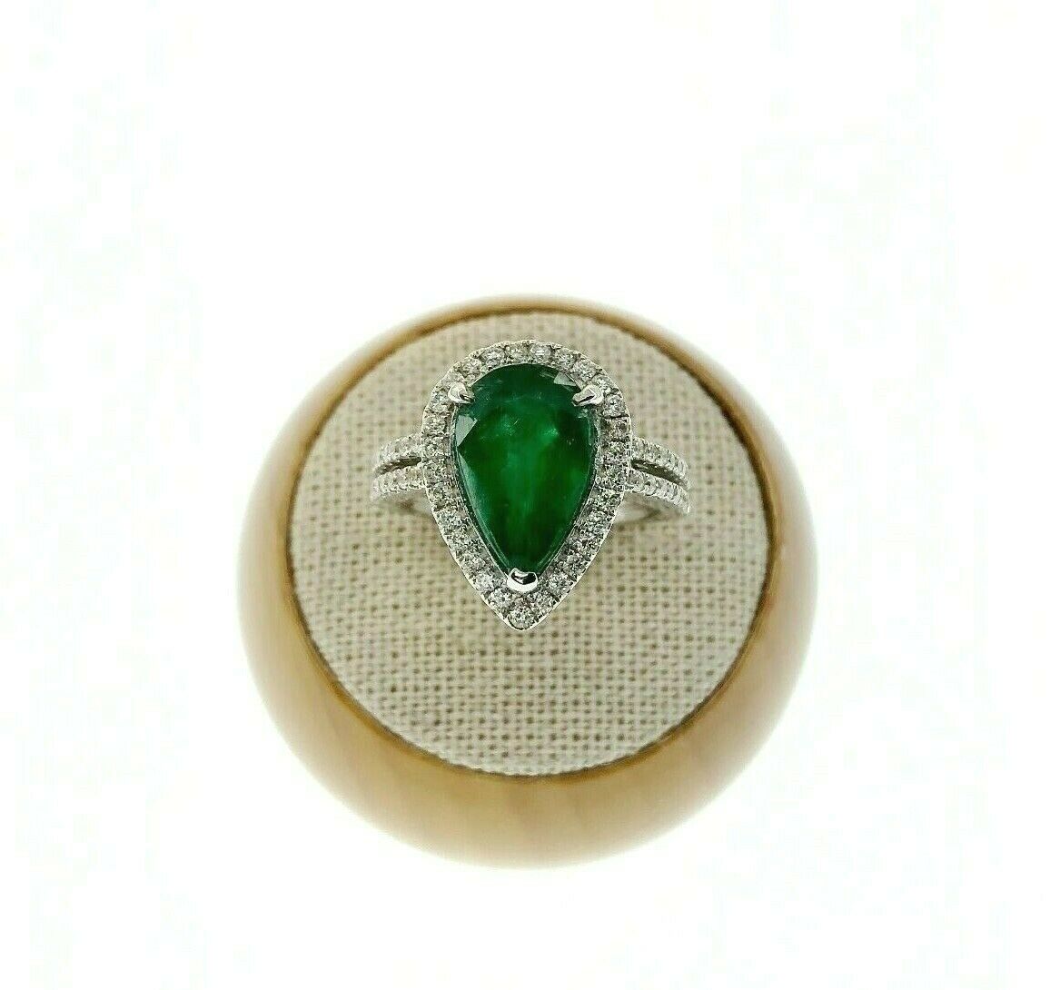 3.82 Carats t.w. Diamond and Emerald Halo Ring 18K Gold Emerald is 3.25 Carats