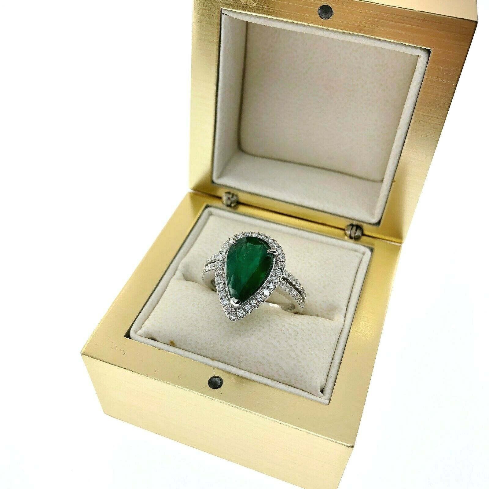 3.82 Carats t.w. Diamond and Emerald Halo Ring 18K Gold Emerald is 3.25 Carats