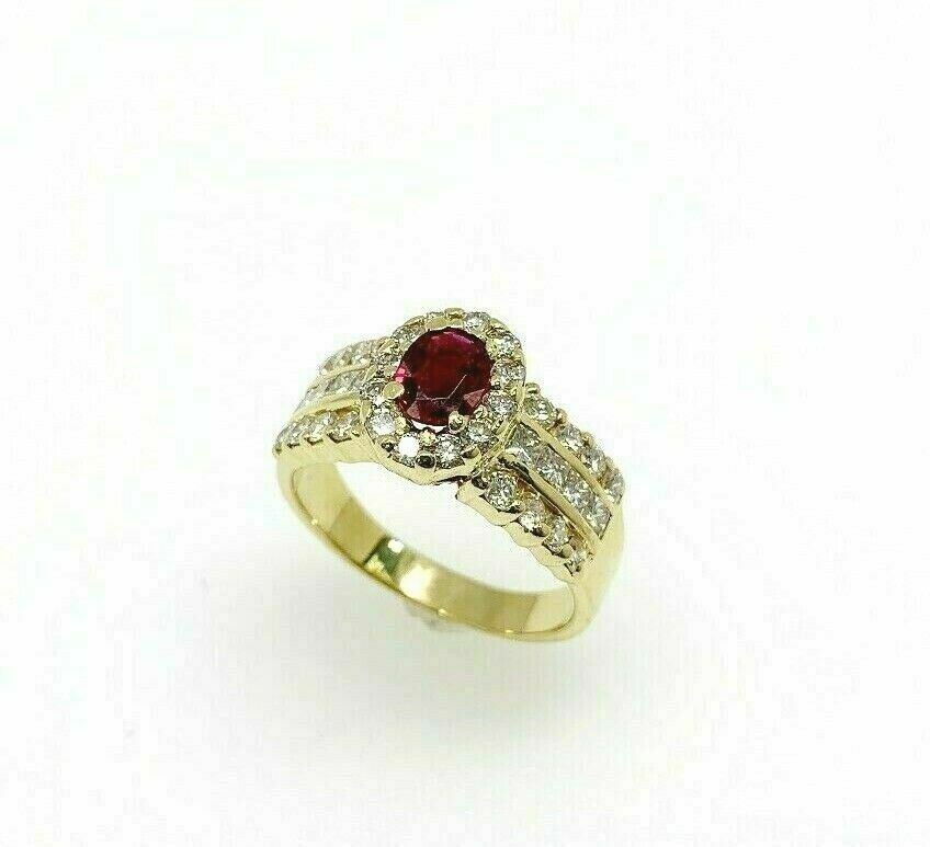 1.45 Carats t.w. Diamond and Oval Ruby Halo Engagement Ring 18K Yellow Gold